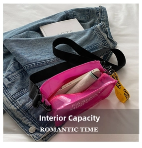 Internal capacity of pink transparent jelly bag with wide nylon strap on denim jacket