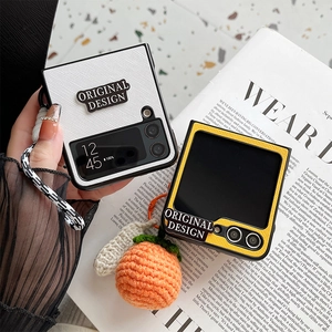 Knitted texture foldable case for Samsung Z Flip 5 with orange charm and striped strap