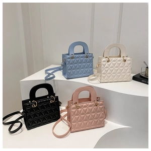 Quilted trapezoid handbags in blue, white, black, and pink with gold ring hardware