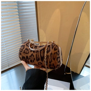 Detail of leopard print faux fur evening bag with rhinestone handle and gold chain strap