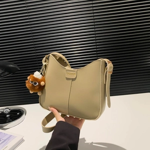Khaki shoulder bucket bag with fashion embossing and a cute brown plush monster charm
