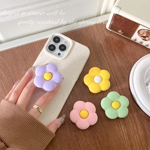 Matte floral phone grip griptok set in pastel colors on a vintage wooden desk