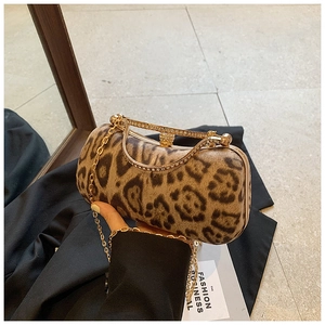 Detail of leopard print evening clutch with gold metal frame and rhinestone clasp