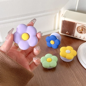 Matte flower-shaped cell phone grip stand in purple, blue, green and yellow colors