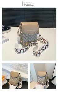 Detail of khaki plaid crossbody bag with leather flap and wide lettered strap