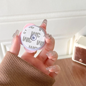 Close-up of pink flower phone grip with circular 3M adhesive on a compact base