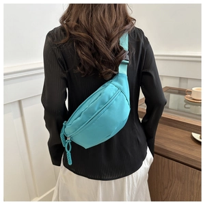 Back view of teal nylon crossbody waist bag showing adjustable strap and buckle