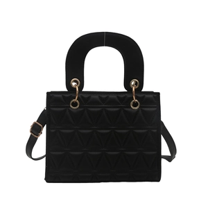 Black quilted handbag with geometric patterns, golden hardware and shoulder strap