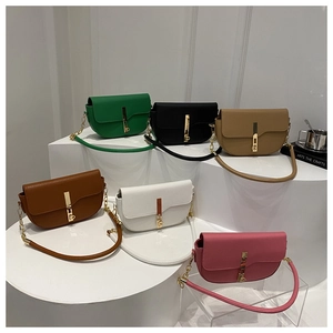 Minimalist leather saddle handbags in six colors with gold clasps on geometric stands