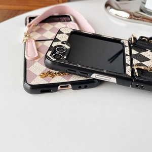 Detail view of leather checkered Samsung Galaxy Z Flip case with metal ring and strap