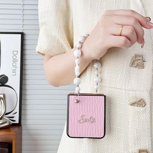 Pink leather flip phone case with pearl handle and rhinestone Smile lettering