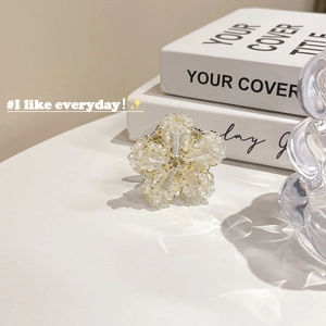 Detailed view of handmade beaded crystal flower phone stand with gold accents