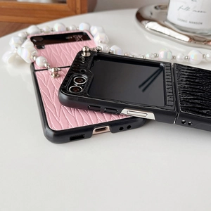 Detail of folding phone case with pleated leather texture and laser pearl hand strap