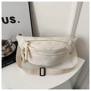 Detail of off-white canvas sling bag with double zippers and adjustable strap