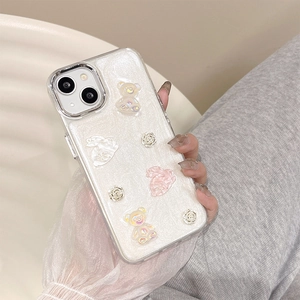 Close-up of sparkling phone case with 3D resin bear, rabbit, and rose decorations