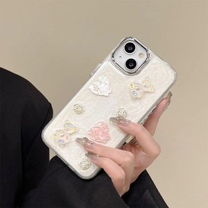 Sparkly floral phone case with 3D resin bear and rabbit for iPhone, held by hand