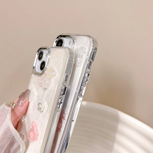 Detailed close-up of iPhone glitter case with 3D resin rabbit, bear, and floral accents