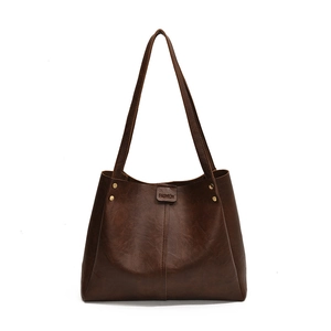 Large brown vintage faux leather tote bag with metal rivets for daily commuting