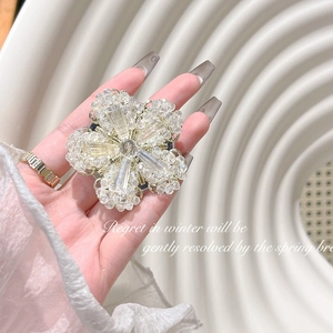 Detail of luxury crystal flower phone grip featuring rhinestones and gold base