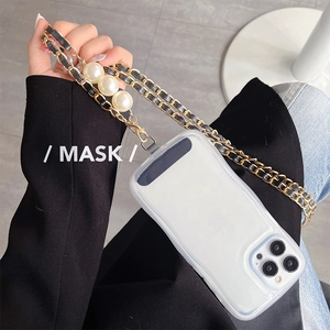 Detailed view of the luxury braided metal chain and white pearls on iPhone case