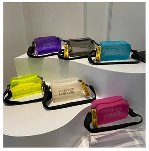 Plusieurs couleurs de sacs bandoulière en PVC transparent sur un escalier blanc épuré