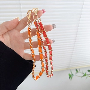 Luxurious gold metal and leather woven phone strap with lobster clasps in red and orange