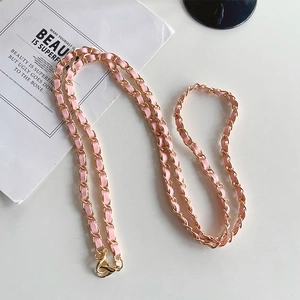 Detail of pink leather woven with gold metal chain strap featuring sturdy lobster clasps