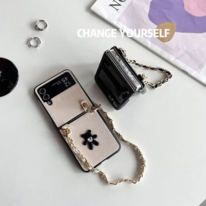 Detail of luxury leather Z Flip 5 cases with rhinestone charms and long crossbody chains
