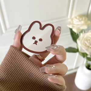 Handheld mirror surface rabbit phone grip holder with a brown border on white background