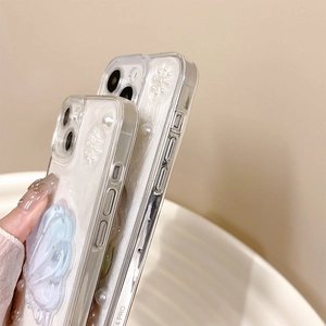 Vue macro détaillée des ornements perles 3D et papillon bleu sur coque iPhone