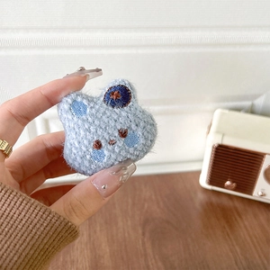 Detail eines hellblauen gestrickten Plüschbären mit Sternenstickerei in der Hand