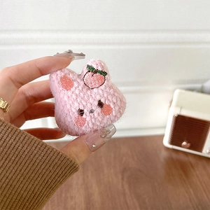Detail eines rosa gestrickten Plüsch-Hasen-Handyhalters mit süßer Pfirsich-Stickerei
