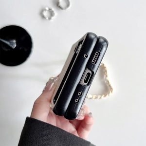 Close-up of leather folding phone case with metal chain strap and precise cutouts