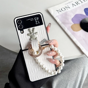 White embossed leather Samsung Z Flip case with rhinestone bear charm and pearl strap