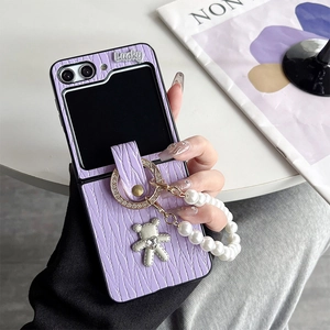 Detail of purple woven phone case for Z Flip with pearl chain and lucky bear charm
