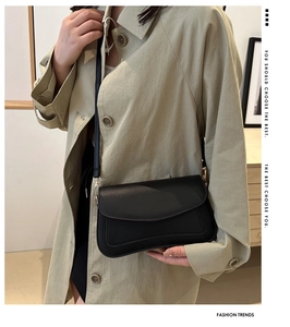 Detail of elegant black square shoulder bag with smooth texture and fine stitching