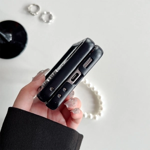Detail of Z Flip 5 phone case featuring black leather texture and silver metal studs