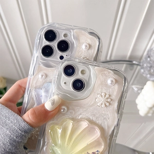 Close-up of luxury iPhone case with 3D pearls, shell patterns and snowflake decor