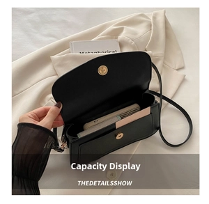 Internal view of black leather crossbody bag showing spacious capacity for phone and cards