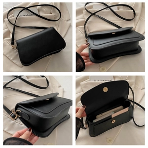 Detailed views of a minimalist black square bag with gold hardware and interior layout