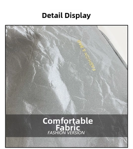Macro view of silver fabric with metallic sheen and yellow Fashion & Bag text logo
