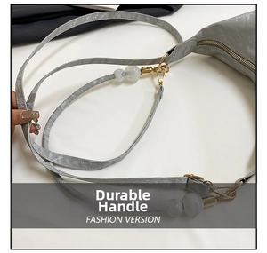 Detail showing golden metal hardware, white beads and marble texture on stylish bag
