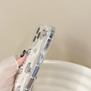 Detail of iPhone case with 3D silver hearts and sparkling rhinestones on pearl marble