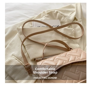 Detail of beige quilted shoulder bag with woven texture on a stylish blazer