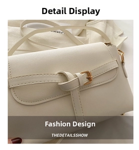 Detail showing creamy white textured leather bag with knot belt buckle and gold hardware