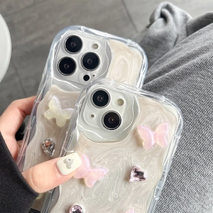 Detail of pink 3D butterfly phone case with rhinestones and cream texture on iPhone