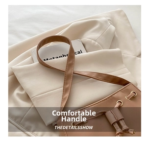 Detail of leather drawstring and metal eyelets on minimalist brown shoulder bag
