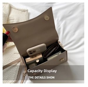 Internal view of beige crocodile embossed square bag showing large storage capacity