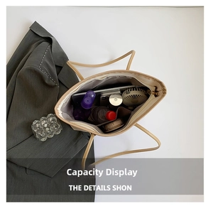 Interior view showing the large capacity of the beige tote bag with daily essentials