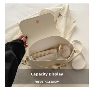Internal view of white leather crossbody bag showing capacity for phone and cosmetics